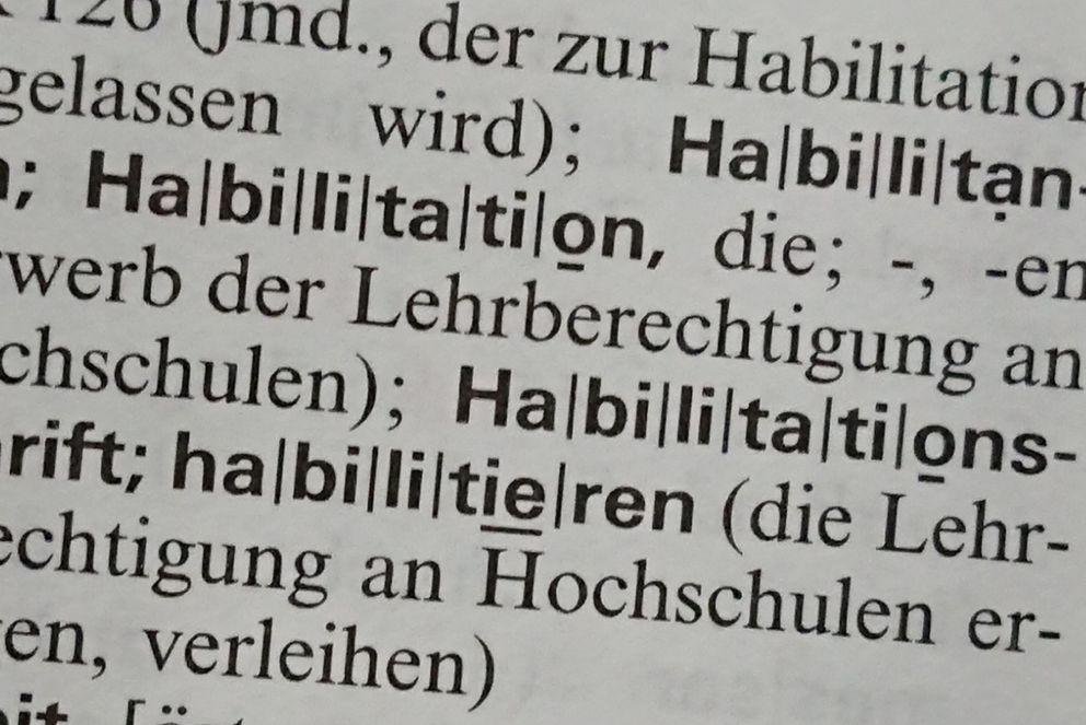 Postdoctoral researchers The picture shows an excerpt from the German dictionary Duden, including the word 'Habilitation'.